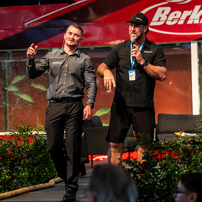 Fishing expert delivering a live fishing masterclass demonstration on stage.